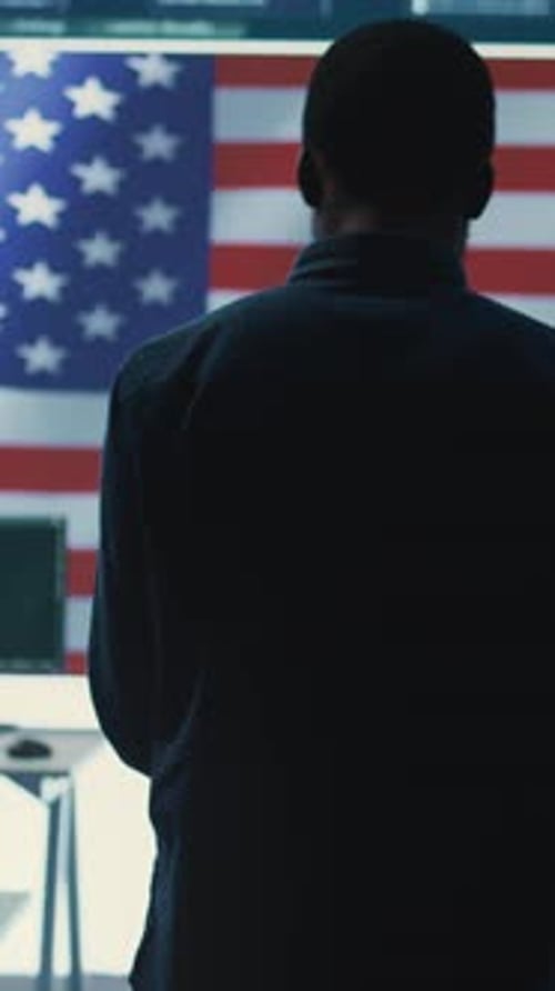 Person Facing American Flag on Screen