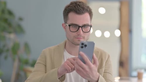 Man Using Smartphone Technology Indoors