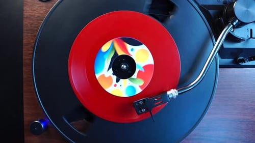 Finishing Playback of Red Single Vinyl Record on Turntable, Top Down View