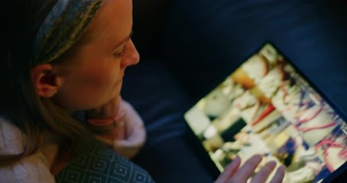 Woman Using Tablet at Home in the Evening
