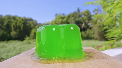 Close Up Shot of Green Jelly Deforming and Shaking After Repeated Spoon Hits, Slow Motion View of
