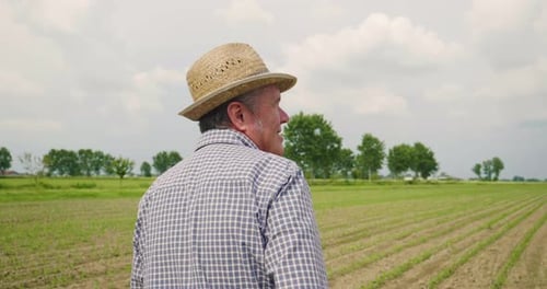 Farmer Walking Through Crops on a Rural Farm