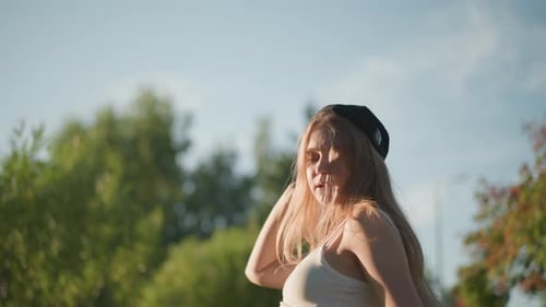 Woman Dancing in the Park on a Sunny Day