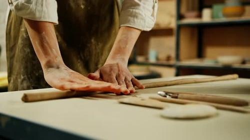 Creating handicraft pottery closeup of working table in ceramics studio with female master
