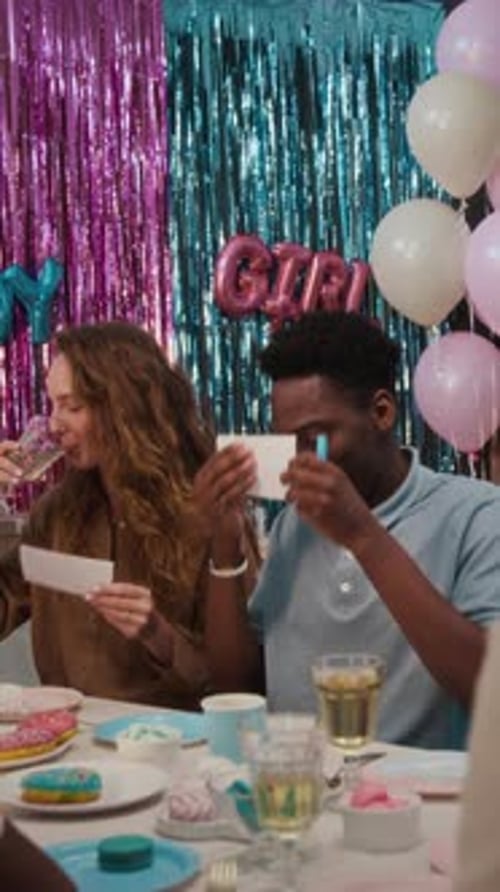 Couple Clinking Glasses with Lemonade and Putting Paper Slips on Foreheads