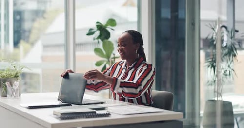 Woman Closing Laptop and Relaxing in Modern Office