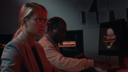 Man and Woman Working Under Pressure in a Tech Office