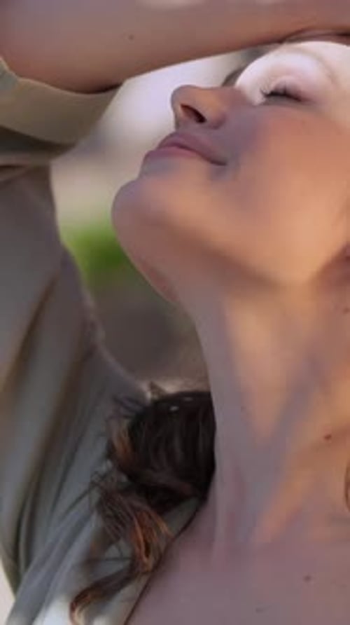 Close-up portrait of a young woman with striking blue eyes and a gentle smile