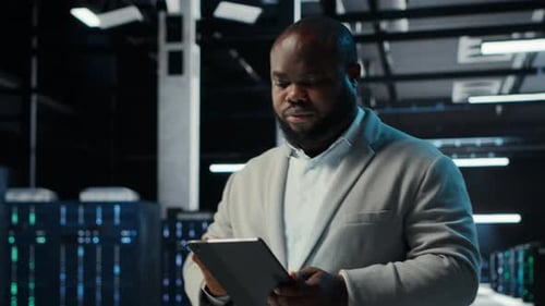 Data Center Engineer Monitoring Servers Performing AI Training