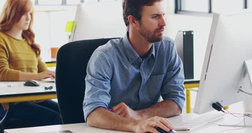 Professional computer designer working on a new software technology design in his office desk