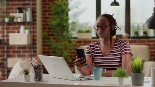 Woman Talking on Phone at Desk