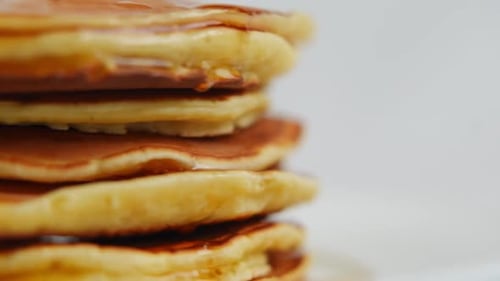 Pancakes Drizzled With Syrup in Delicious Close Up