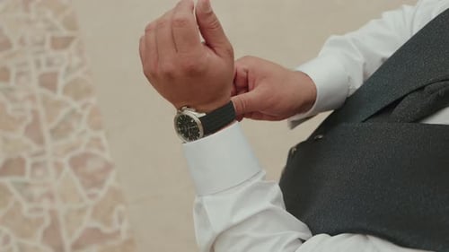 Man Adjusting Stylish Watch Before an Event