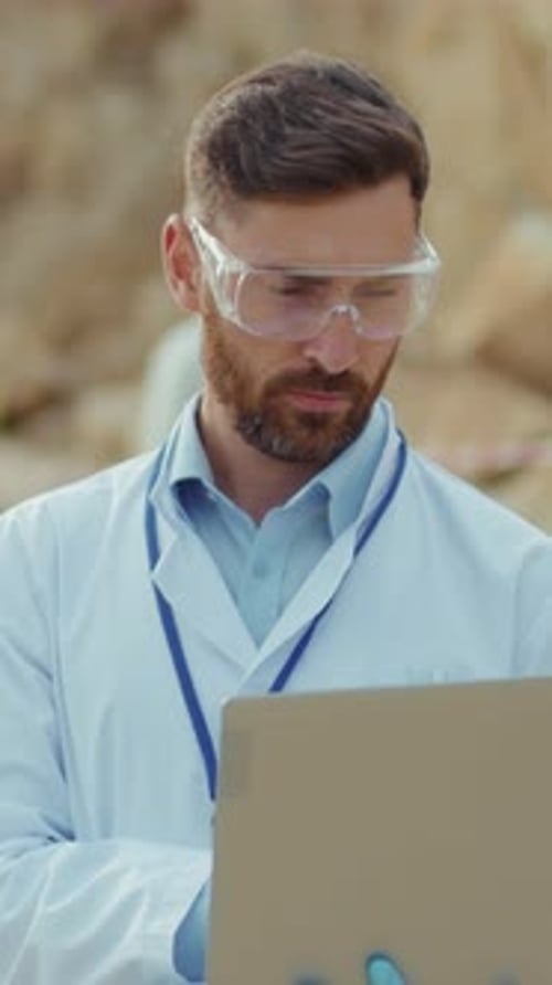 A Dedicated Scientist is Analyzing Data on Their Laptop in a Serene Field Environment