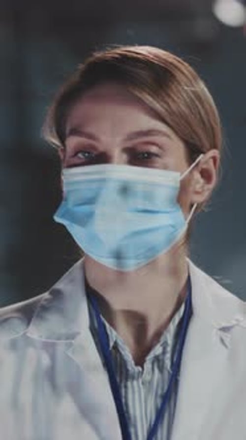 Dedicated Female Doctor in Hospital Corridor Meticulously Preparing for Thorough Patient Examination