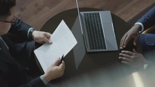 Businessmen Signing Agreement During Corporate Meeting