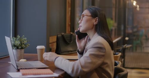 Woman Talking on Phone in Corporate Office Environment