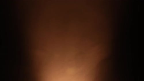 Flow Stage of Formless Smoke Swirling Against a Black Background