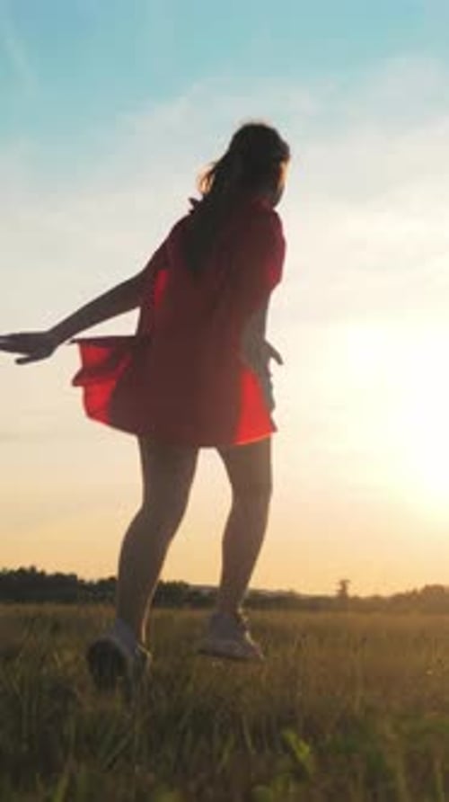 Happy Little Girl with Red Cape Running in Rye Field in Summer Rear View Dreaming to Be Superhero