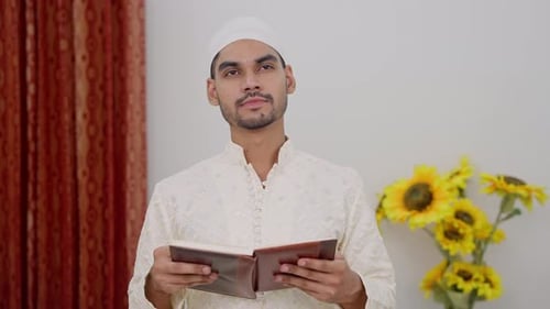 Thoughtful Man Reading Religious Book Indoors