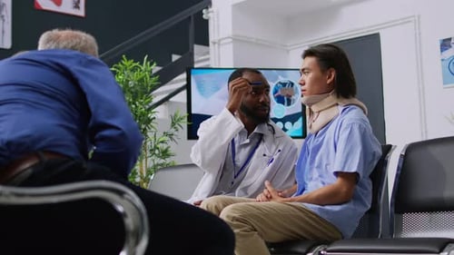 Doctor Talking with Patient Wearing a Neck Brace