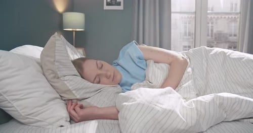 Woman Sleeping Peacefully in Bed in the Daylight