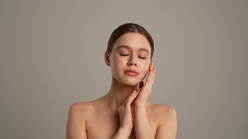 Beautiful woman poses with hands on face