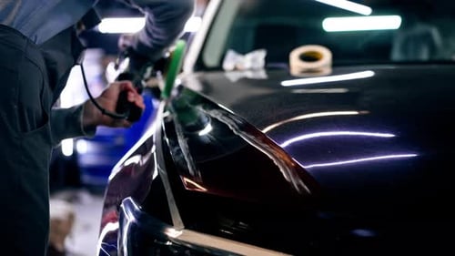 the Car Mechanic at a Service Station Doing the Final Polishing to Shine