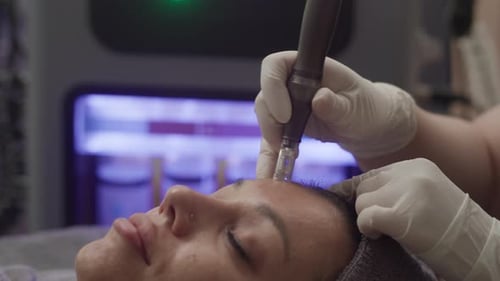 Woman receiving cosmetic procedure on her forehead