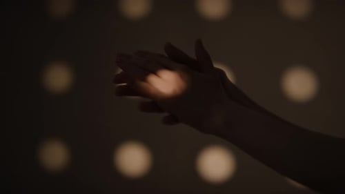 Hands Rubbing Together in Warm Light