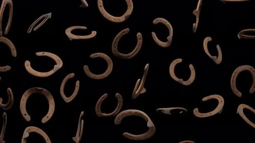 3D Falling Horseshoes Seamless Loop on Black Background