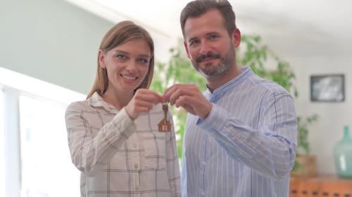 Happy Young Couple Showing Home Keys