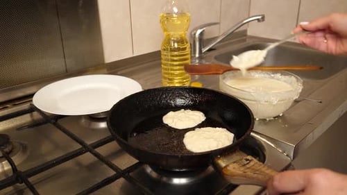 Pancakes Cooking in Pan in Kitchen
