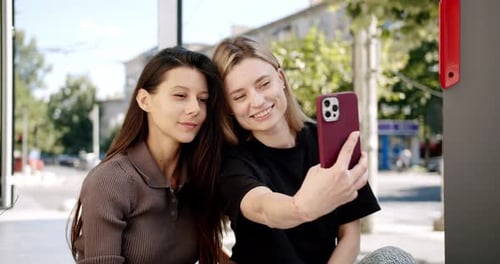 Young Women Using Smartphone on Street
