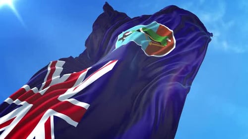 Waving Flag of Montserrat Against Blue Sky