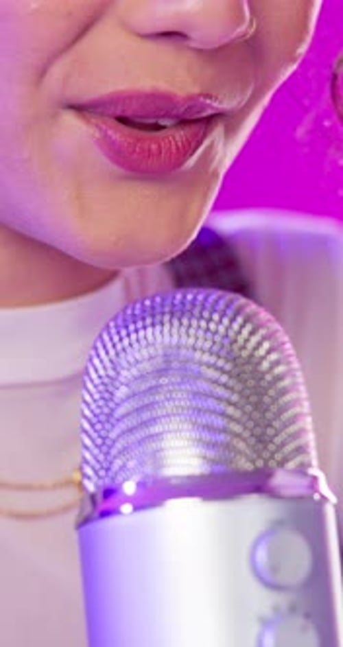 Young Adult Talking Into Microphone Close Up