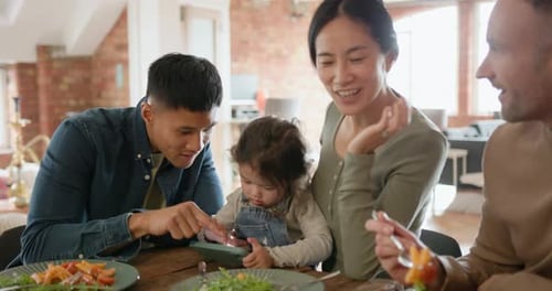Family Meal Together at Home with Child and Tablet