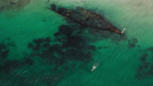 Aerial View of a Shipwreck in Clear Turquoise Waters
