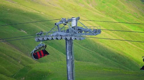 Ski Lift Ascending Over Green Mountain Landscape