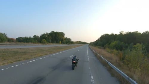 Camera Moving Around of Biker Riding on Modern Sport Motorbike at Highway Motorcyclist Racing His