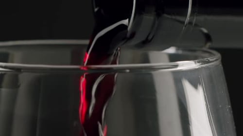 Pouring Red Wine into a Glass Close-Up Shot
