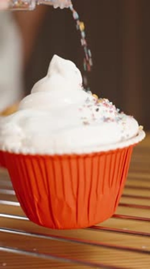 Decorating a Delicious Cupcake with Colorful Sprinkles