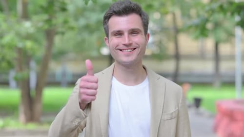 Enthusiastic Man Giving Thumbs Up in Green Park