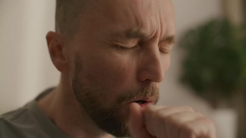 Close Up of Man Coughing while Suffering from Disease at Home