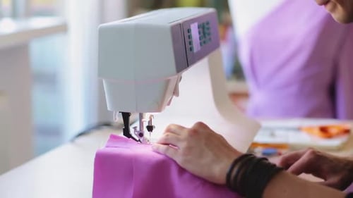 Fashion designer creatively working on garment in studio workshop