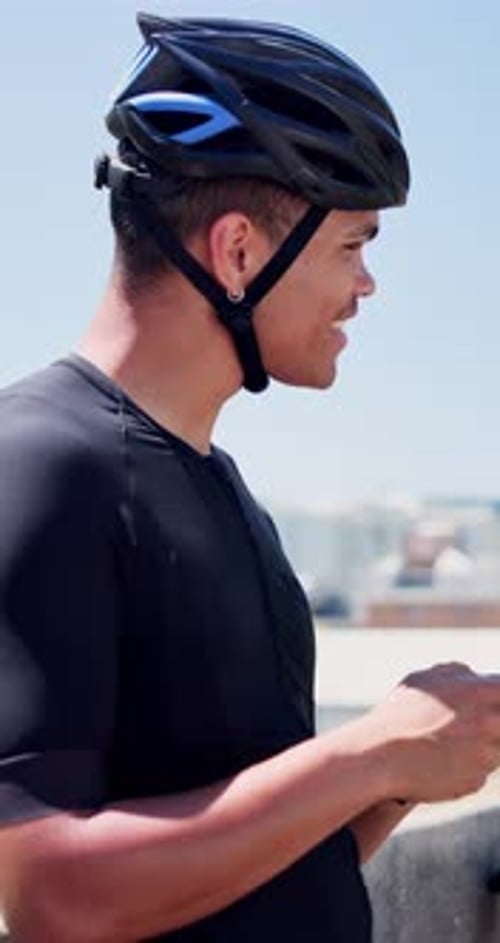 Happy man, phone and exercise with bicycle in city with typing, break and fitness app on bridge