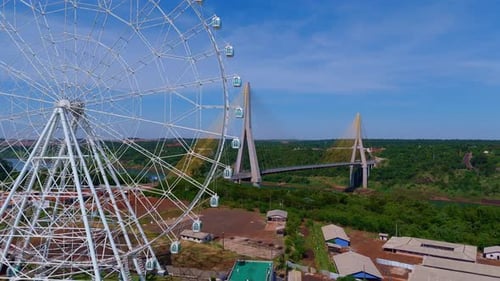 aerial view of the ferris wheel in Foz do Iguaçu with the Brazil-Paraguay Integration Bridge in the