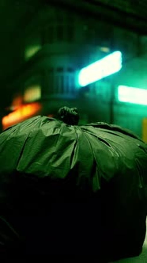 A Garbage Bag Sitting on the Ground in Front of a Building