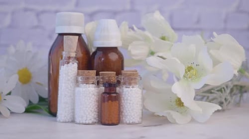 Homeopathic Medicine Bottles with Flowers Still Life