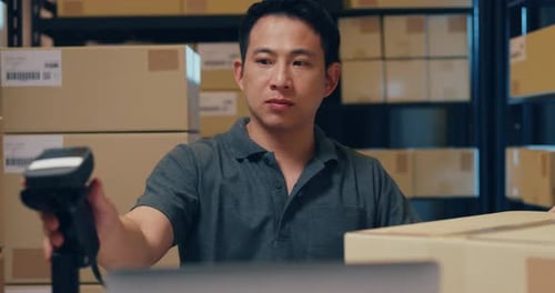 businessman use barcode machine scan customer data in paper box and type register online.